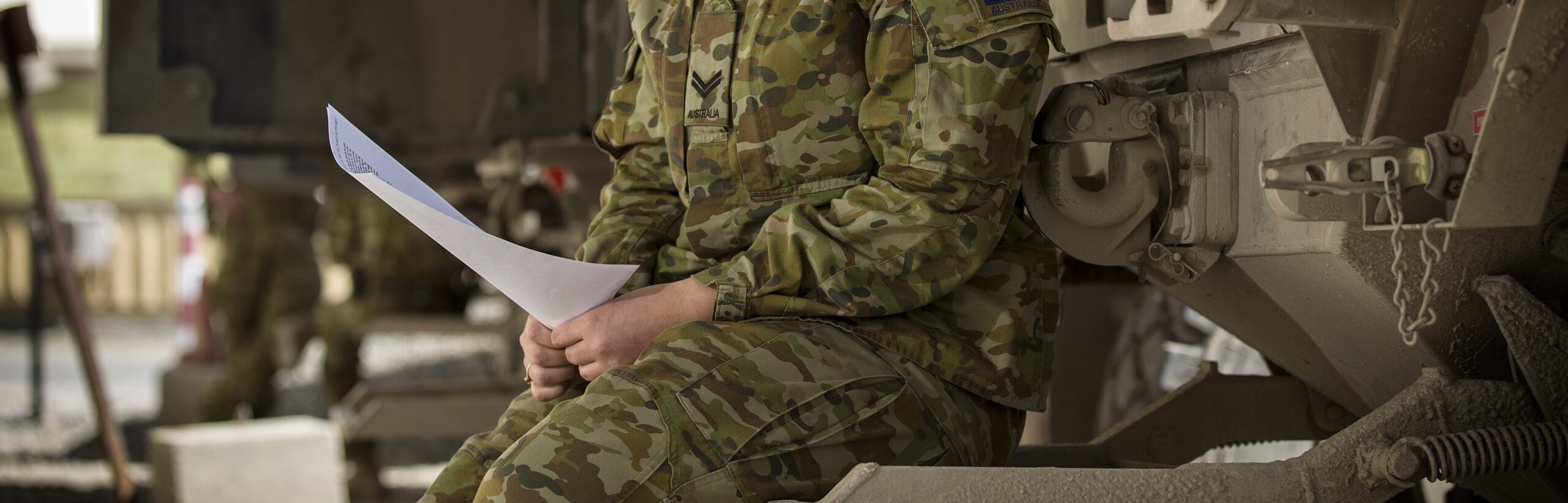 Australian Army soldier Corporal Caitlyn Elleray reads a letter from a distant relative writing about his account of the landing at Gallipoli.